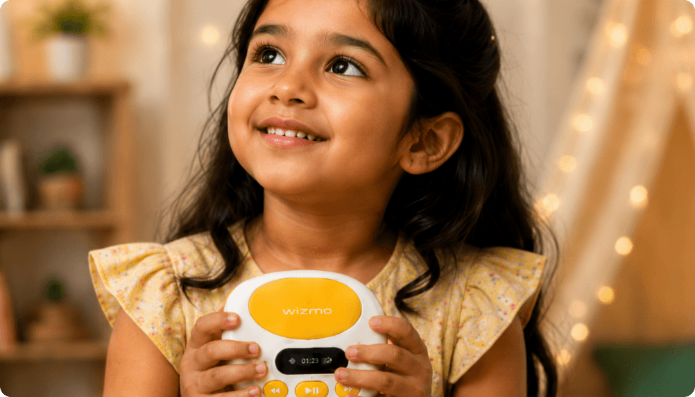 A smiling girl looking up while holding the Wizmo player